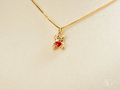 Golden Cub Bear Pendant in 18k gold with a red heart on a delicate chain necklace