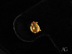 Teardrop-shaped 18k gold citrine earrings featuring pear-cut citrine gemstones