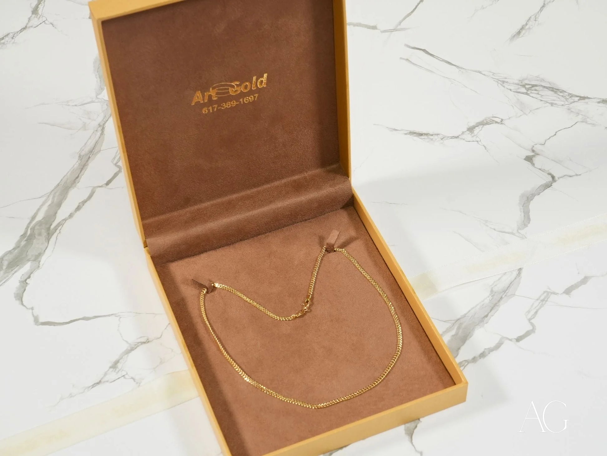 Gold necklace in a presentation box featuring the Golden Luxe Cuban Link Chain in 18K gold