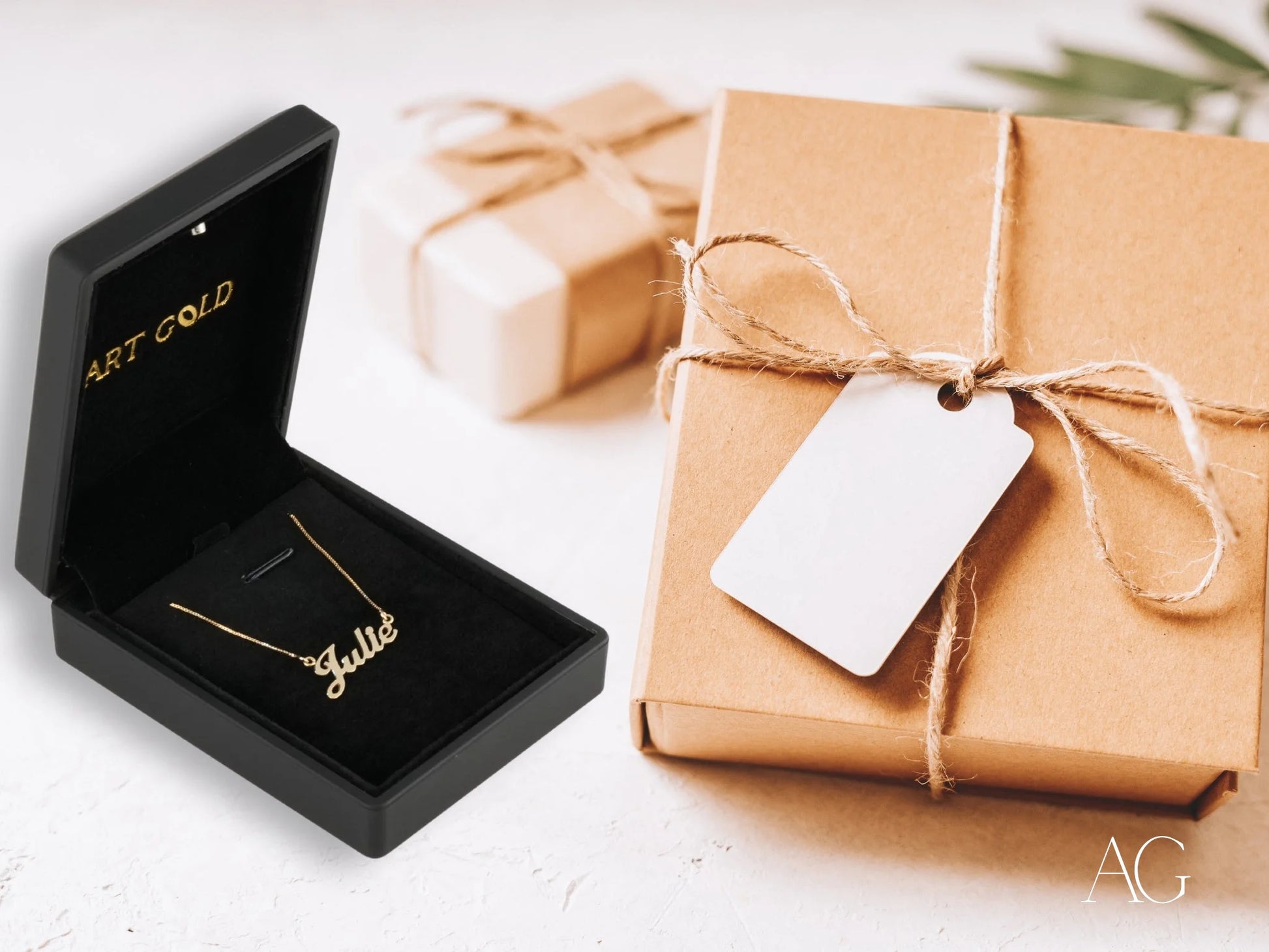 Gold necklace with spring ring lock in black box beside kraft paper gift for Golden Signature