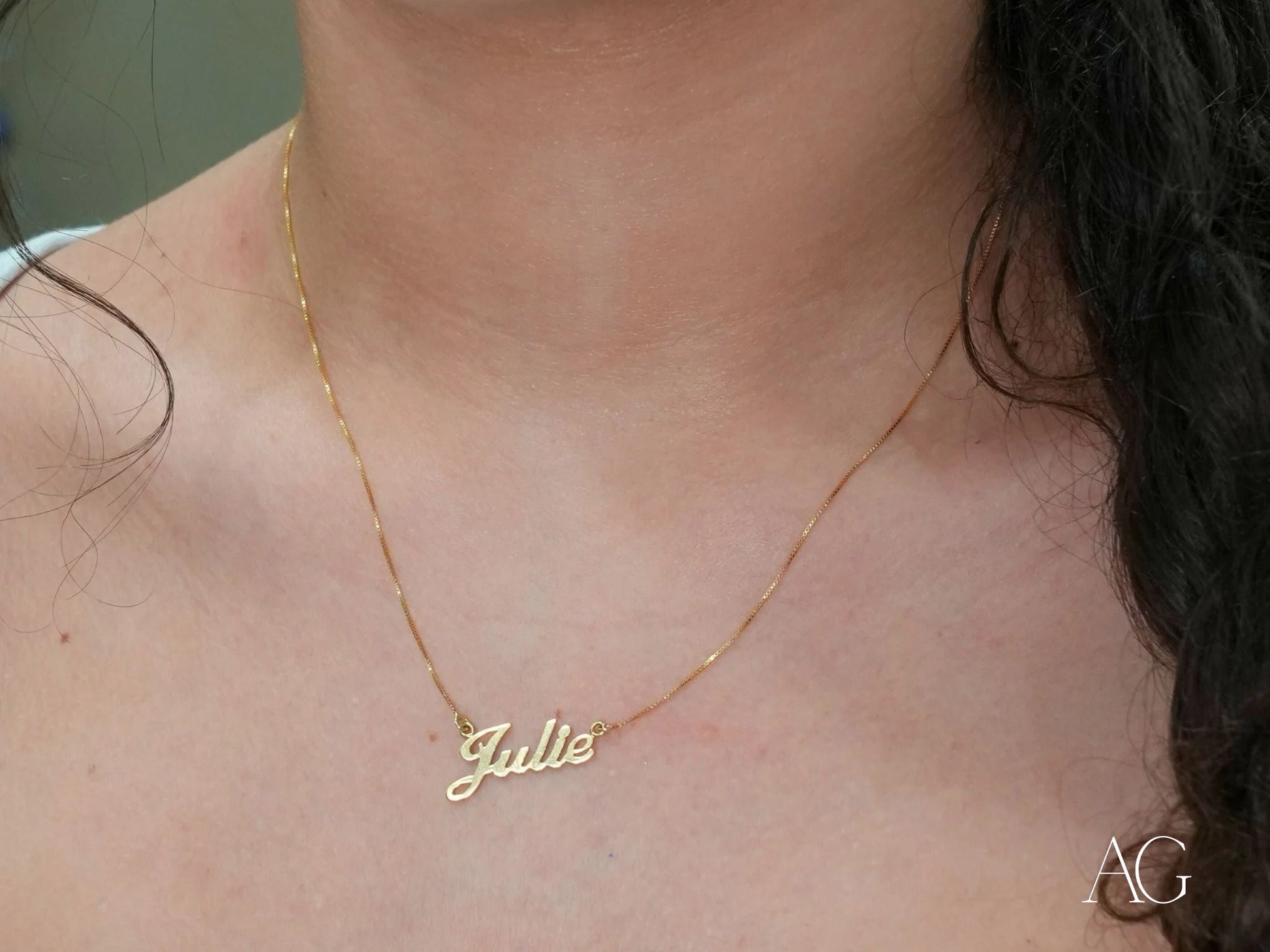 Gold-colored Julie name necklace in 14k gold with a delicate spring ring lock chain