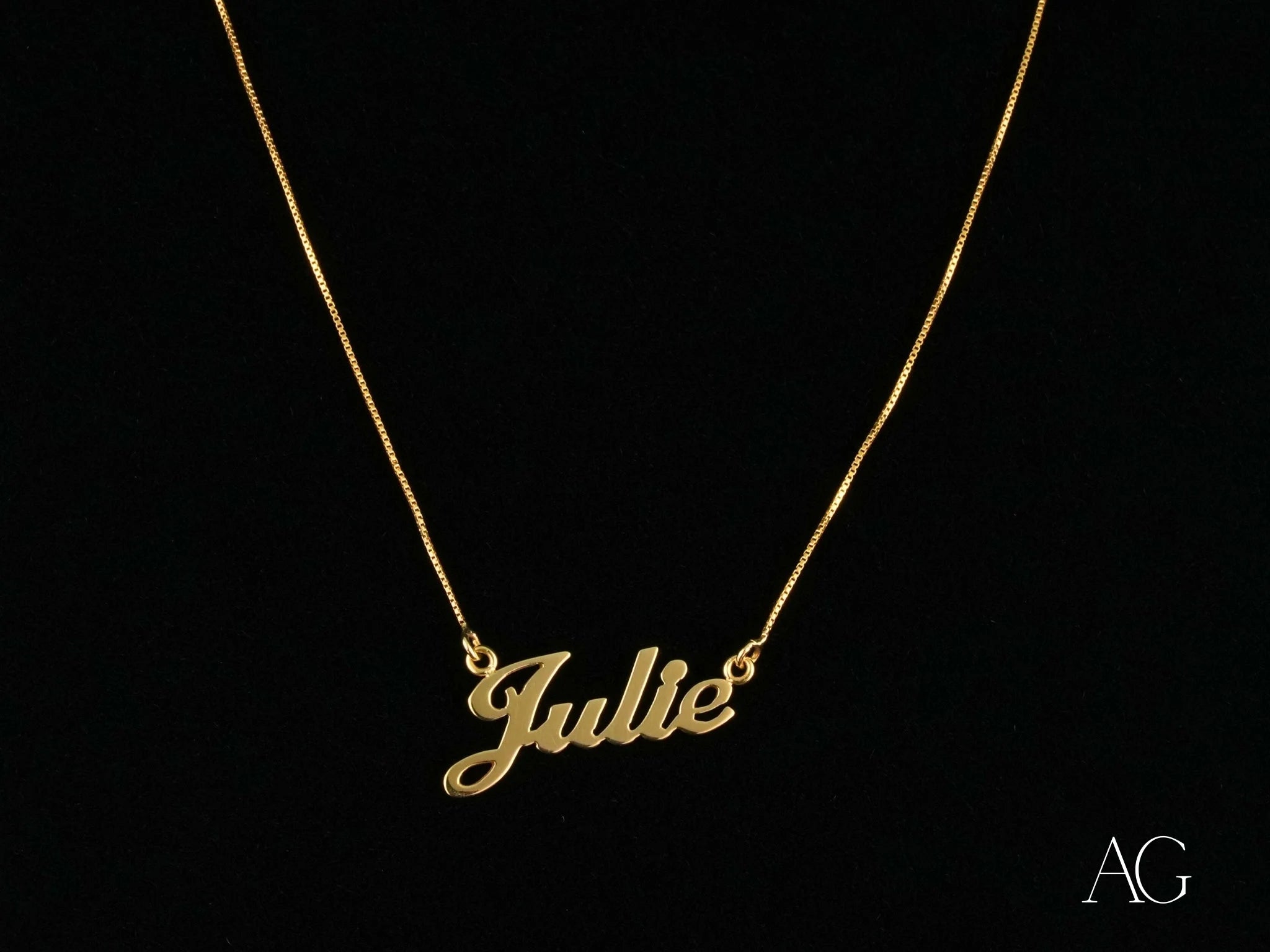 Gold necklace with Julie in cursive script featuring a secure spring ring lock in 18k gold