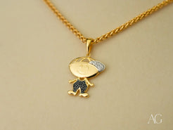 Gold pendant necklace featuring a cartoon character with blue and white crystals, Golden Son