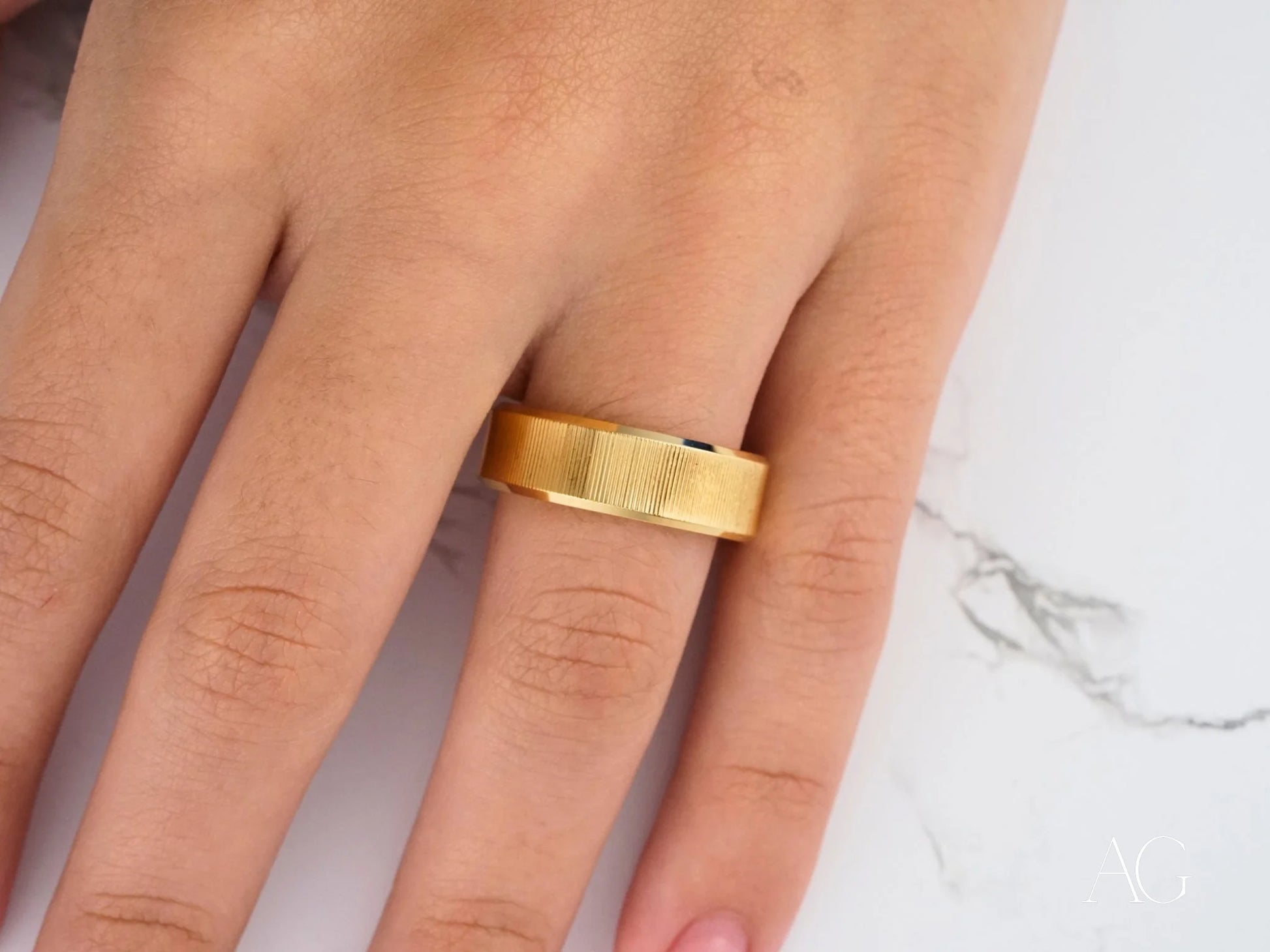 Gold Wedding Band on a finger, showcasing the classic fit of Golden Whisper in 14k gold