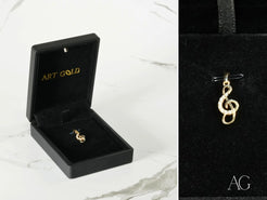 Gold treble clef pendant in a black box for Harmonic Elegance collection