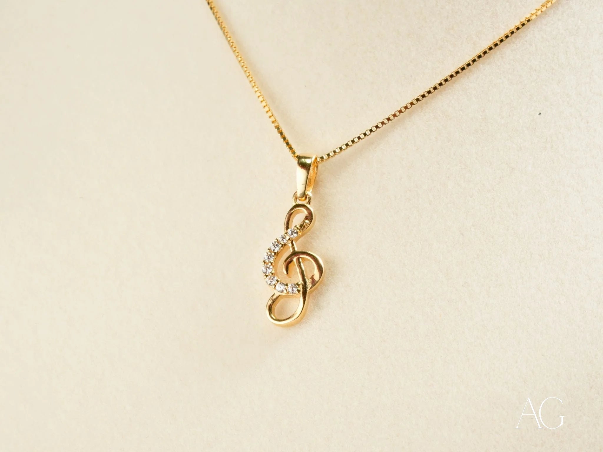 Gold-toned treble clef pendant necklace with rhinestones from Harmonic Elegance collection