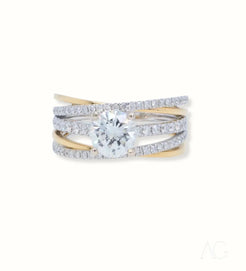 Diamond engagement ring featuring intertwined 18k white and yellow gold bands with 1ct diamond