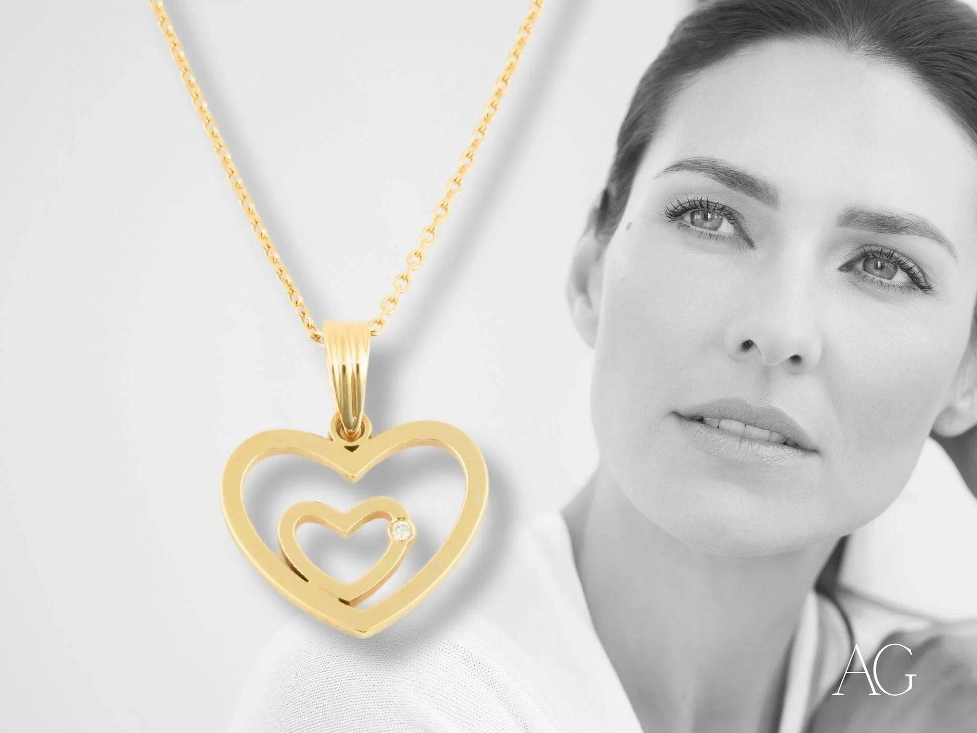 Heart pendant in 14k yellow gold featuring a smaller heart cutout inside