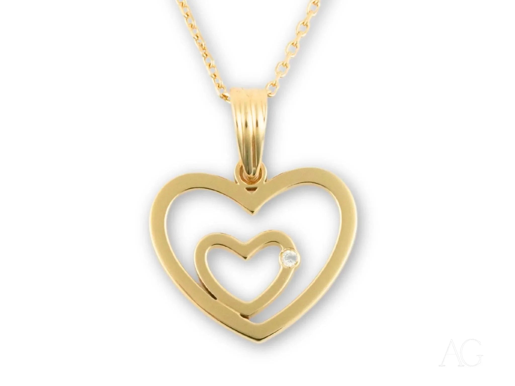 Gold heart pendant with a smaller heart cutout in 14k yellow gold design