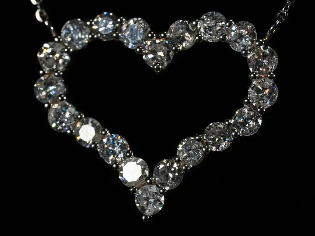 Heart-shaped pendant made of sparkling diamonds or crystals on a chain.