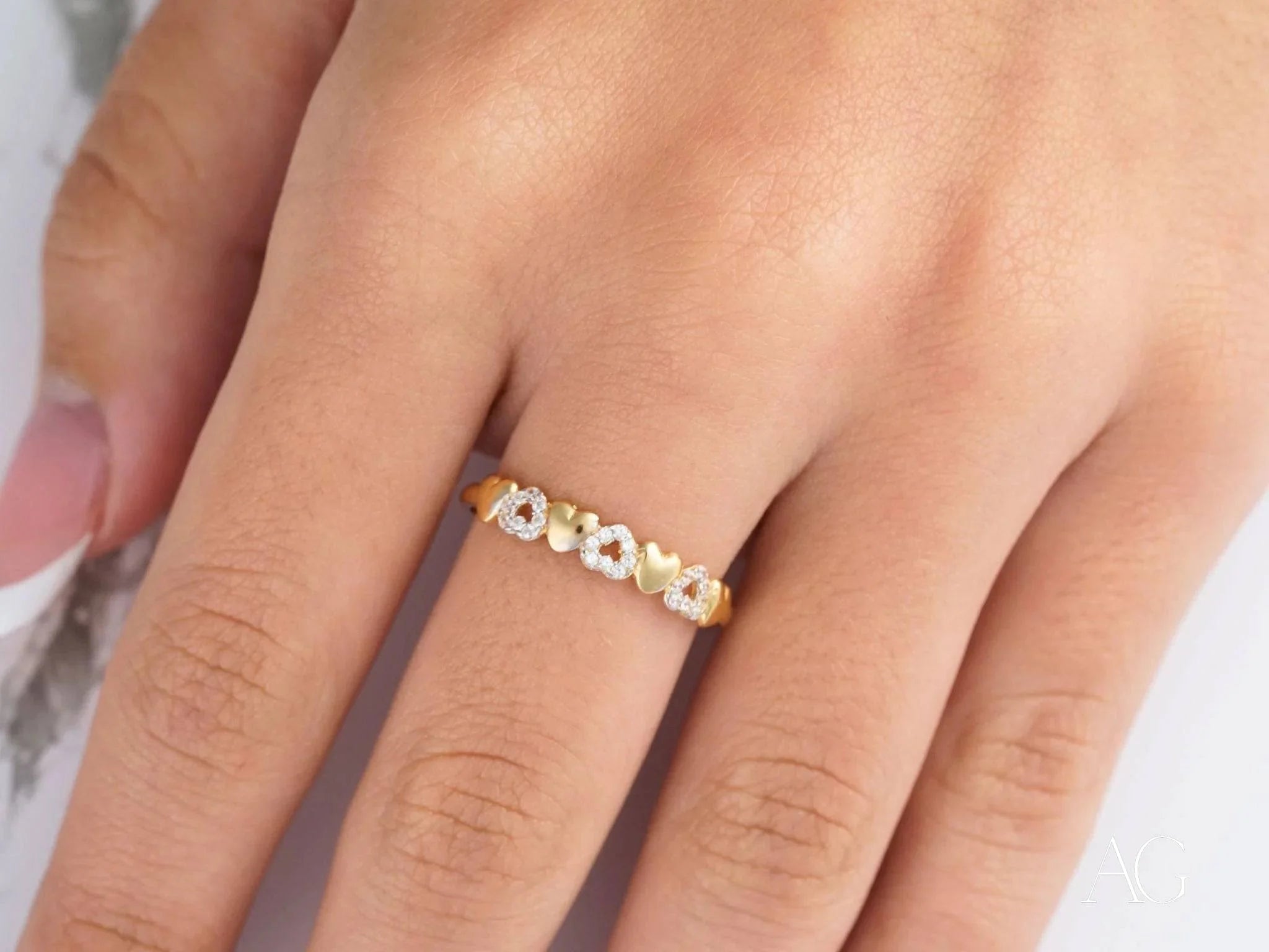 Gold ring with white gemstones in floral pattern, showcasing 18k yellow gold elegance