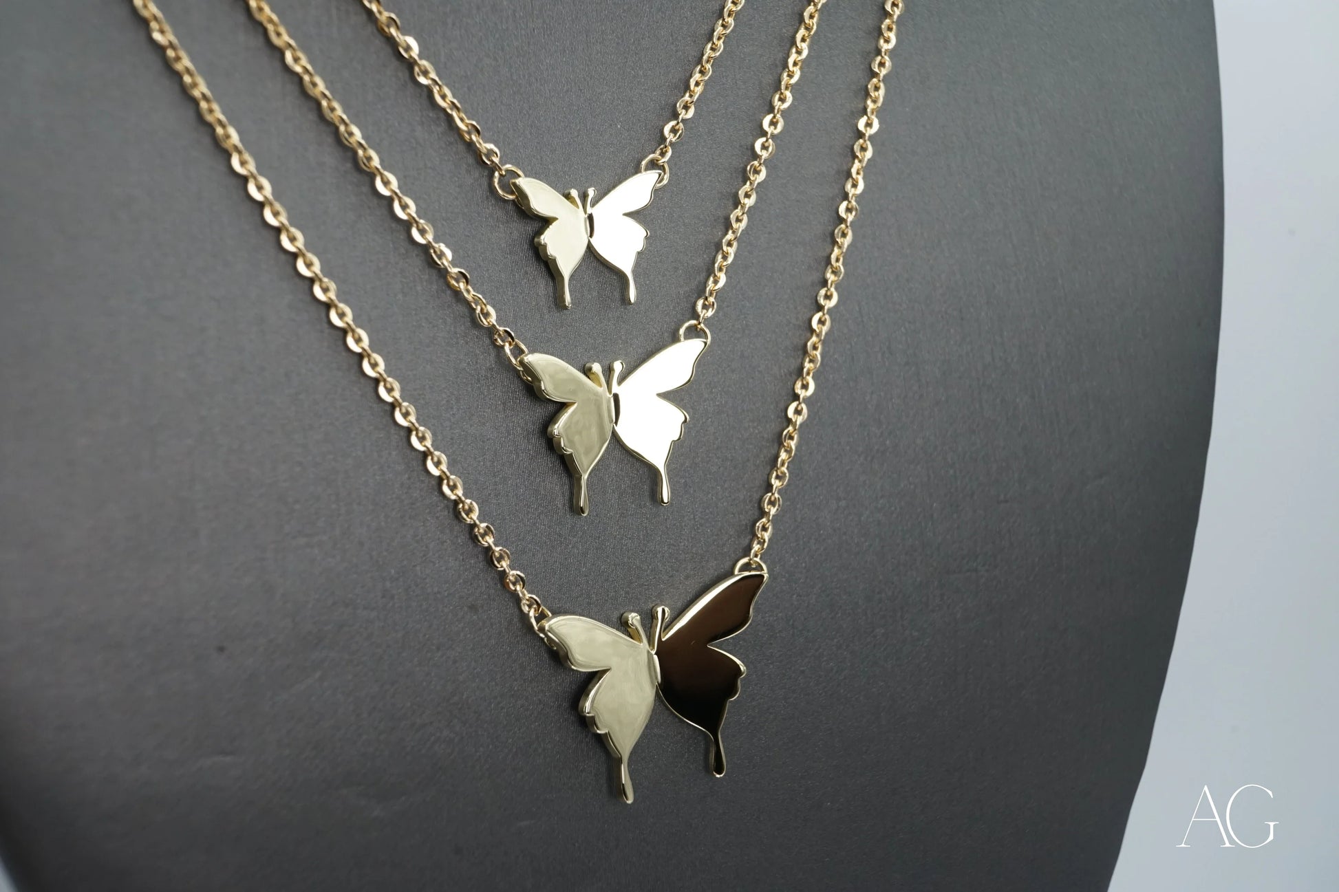 Three-tiered gold necklace with butterfly pendants from Limitless Custom Jewelry Designs