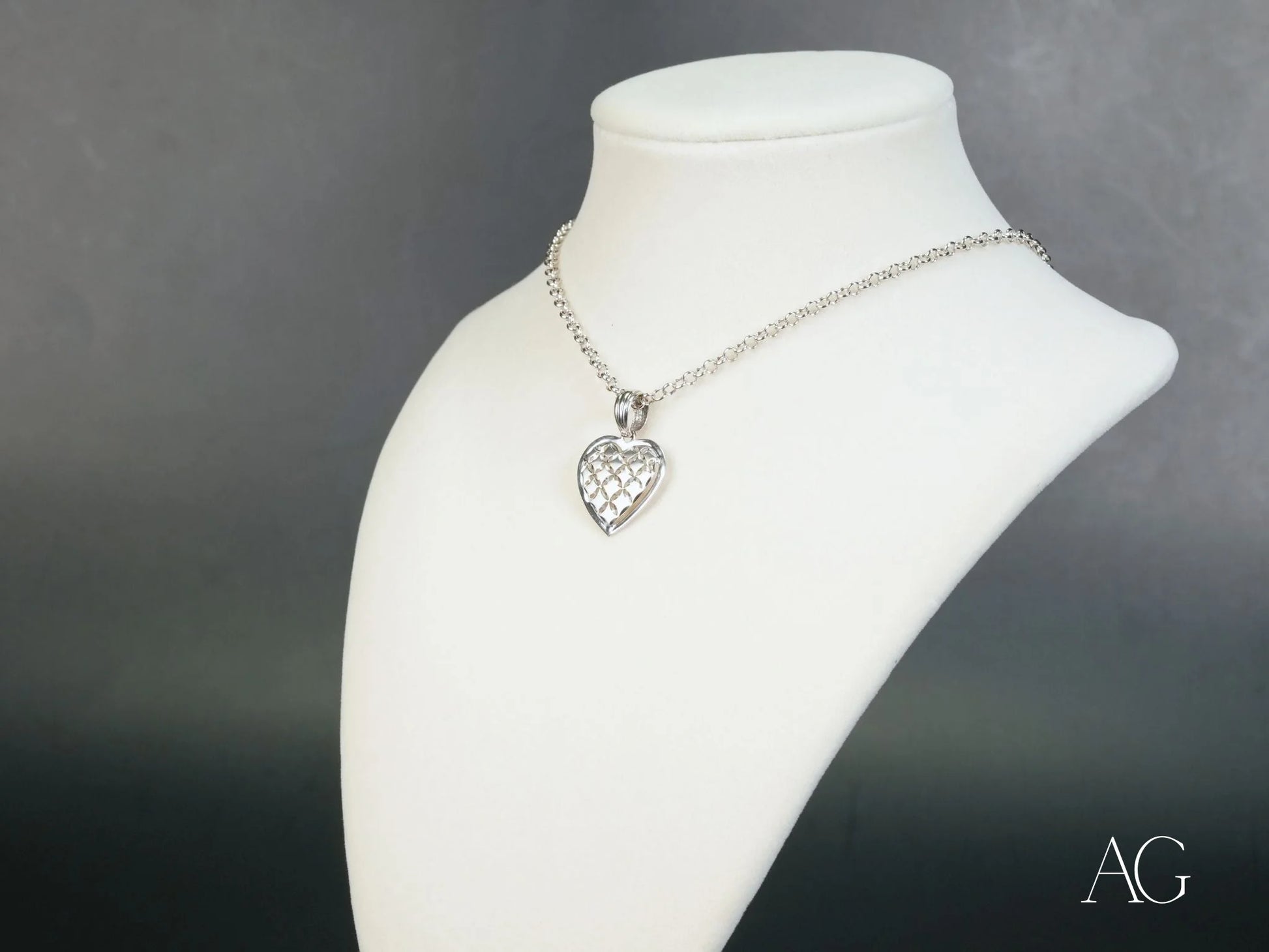 Silver heart-shaped pendant necklace in 18k white gold filigree design on a chain