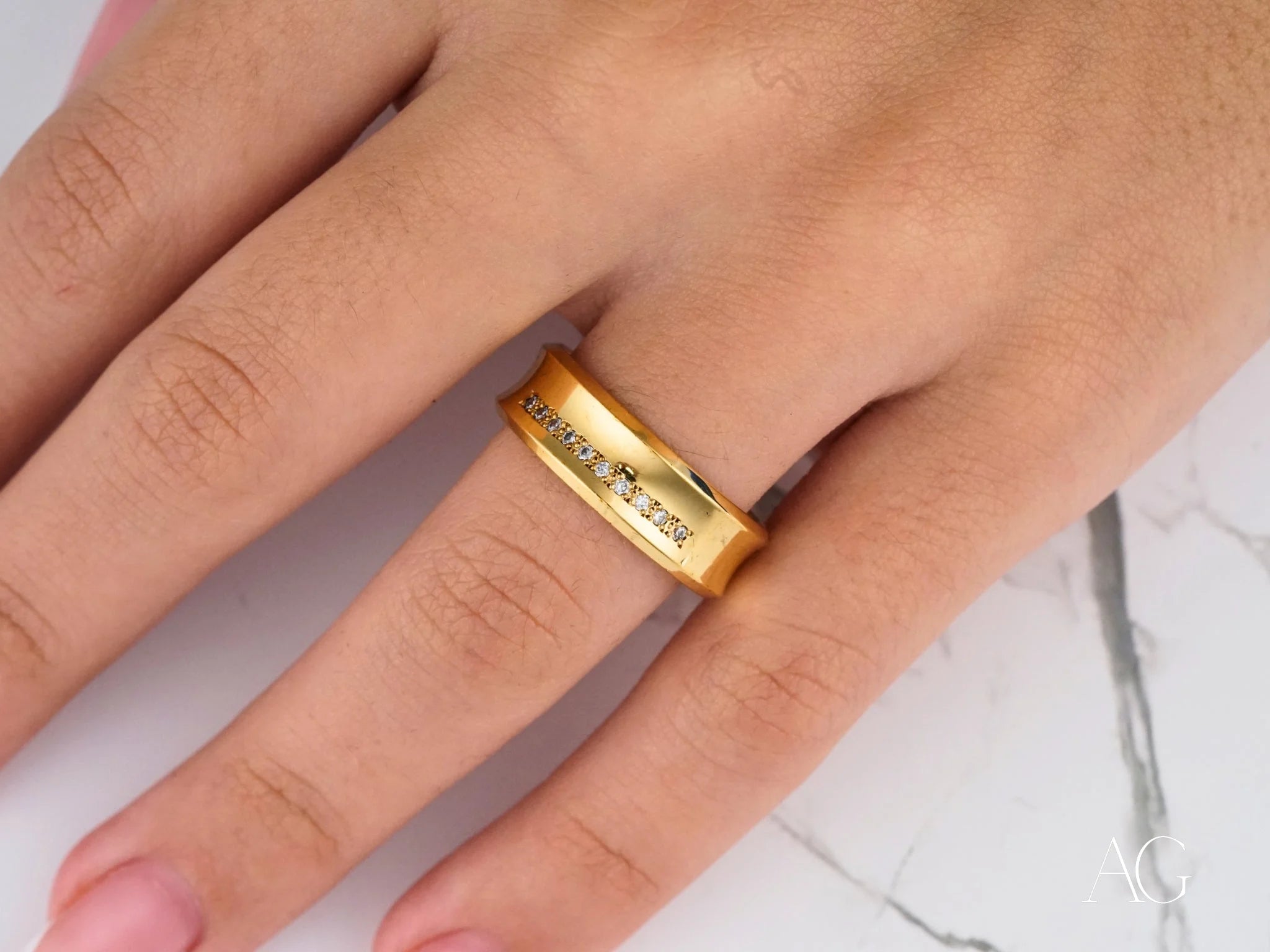 Gold Luminous Path Wedding Band in 14k gold with engraved text on a finger