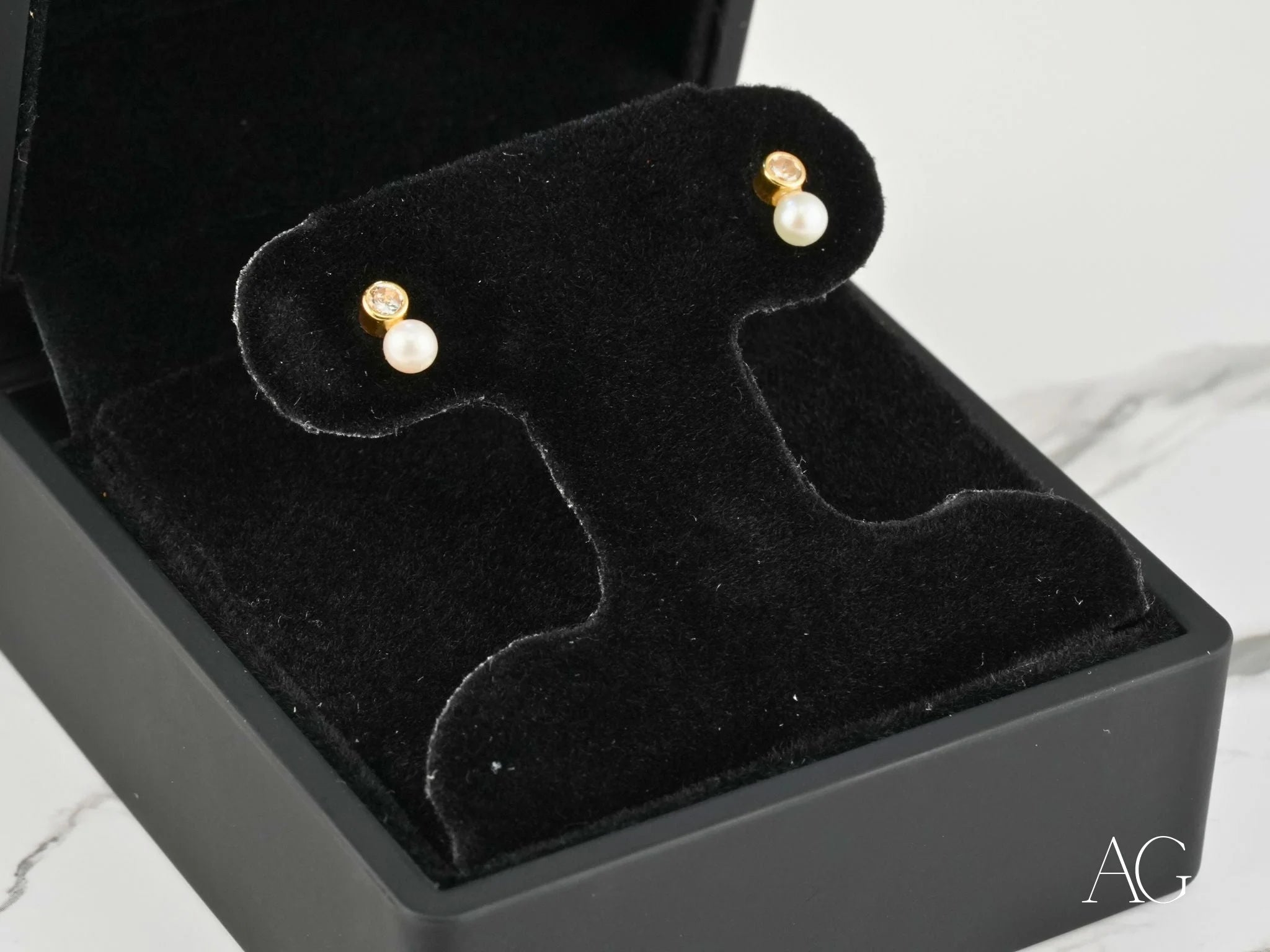 Lustrous Harmony 18K Gold Pearl and CZ Drop Earrings showcased elegantly