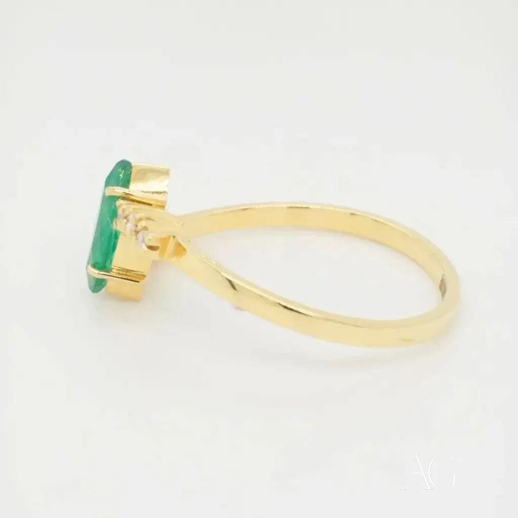 Gold ring featuring an emerald-cut green gemstone in a luxurious emerald marquise ring