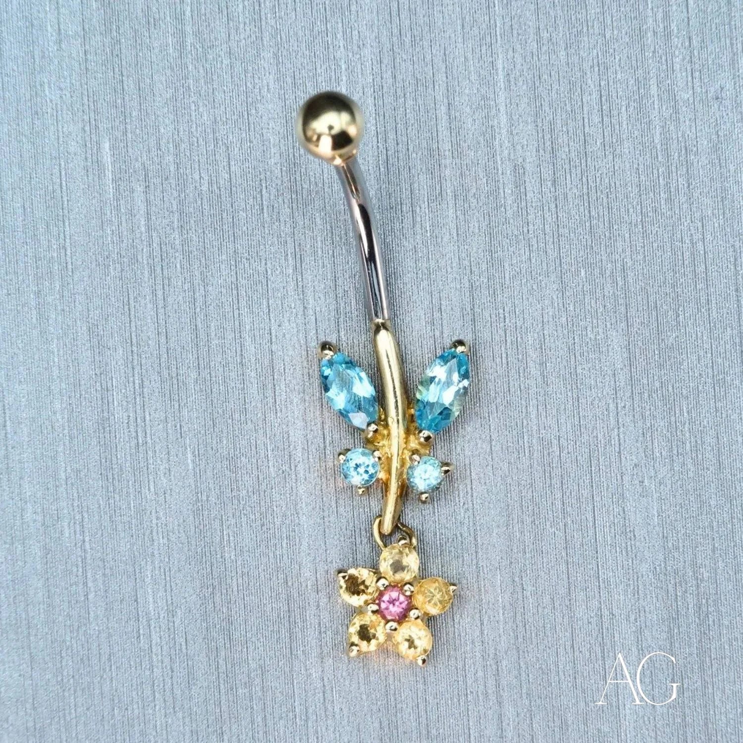 Butterfly-shaped bellybutton piercing in 18k gold with colorful gemstones for luxury style