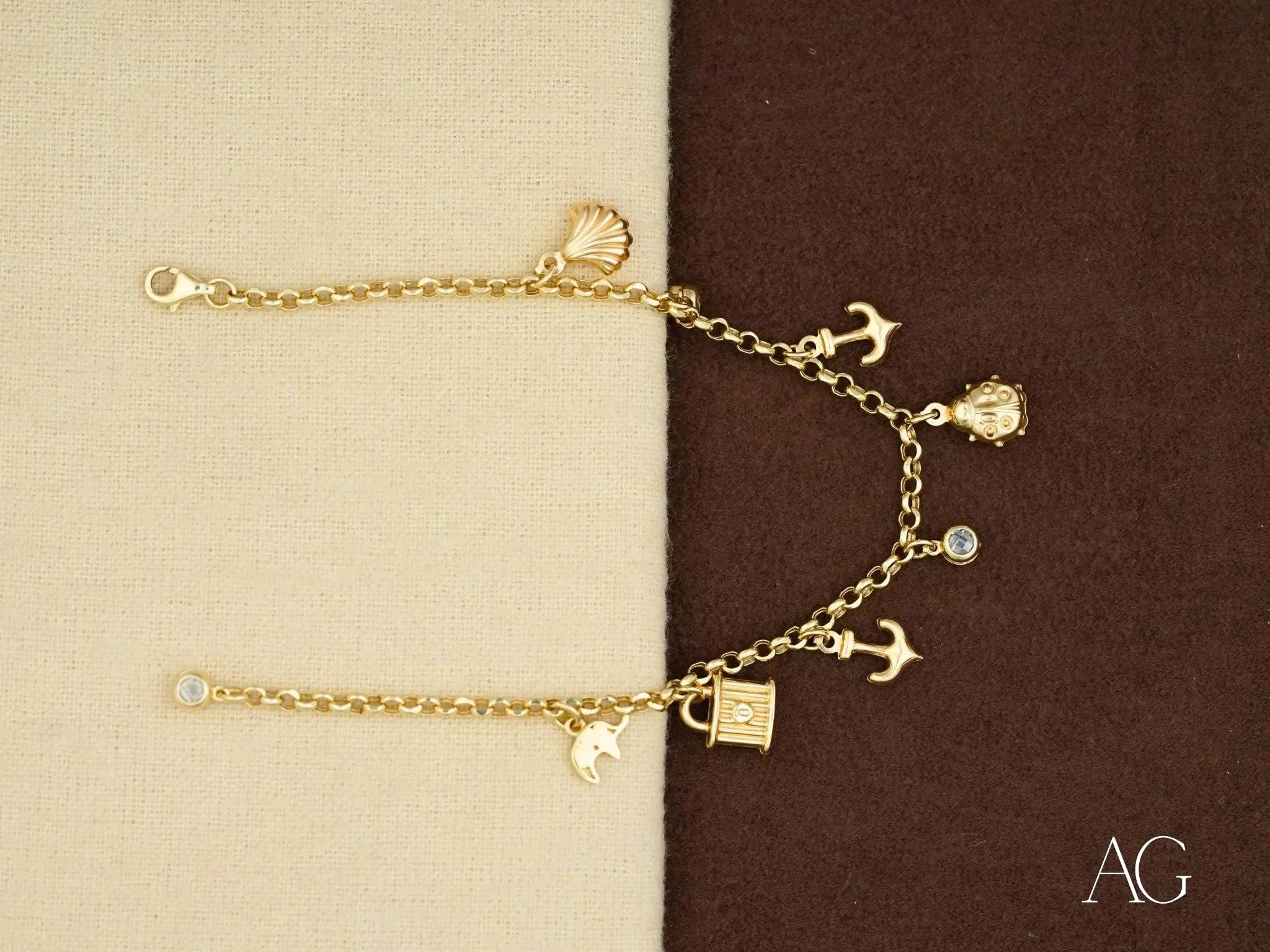 18k gold charm bracelet featuring nautical elegance with anchors and a padlock charm