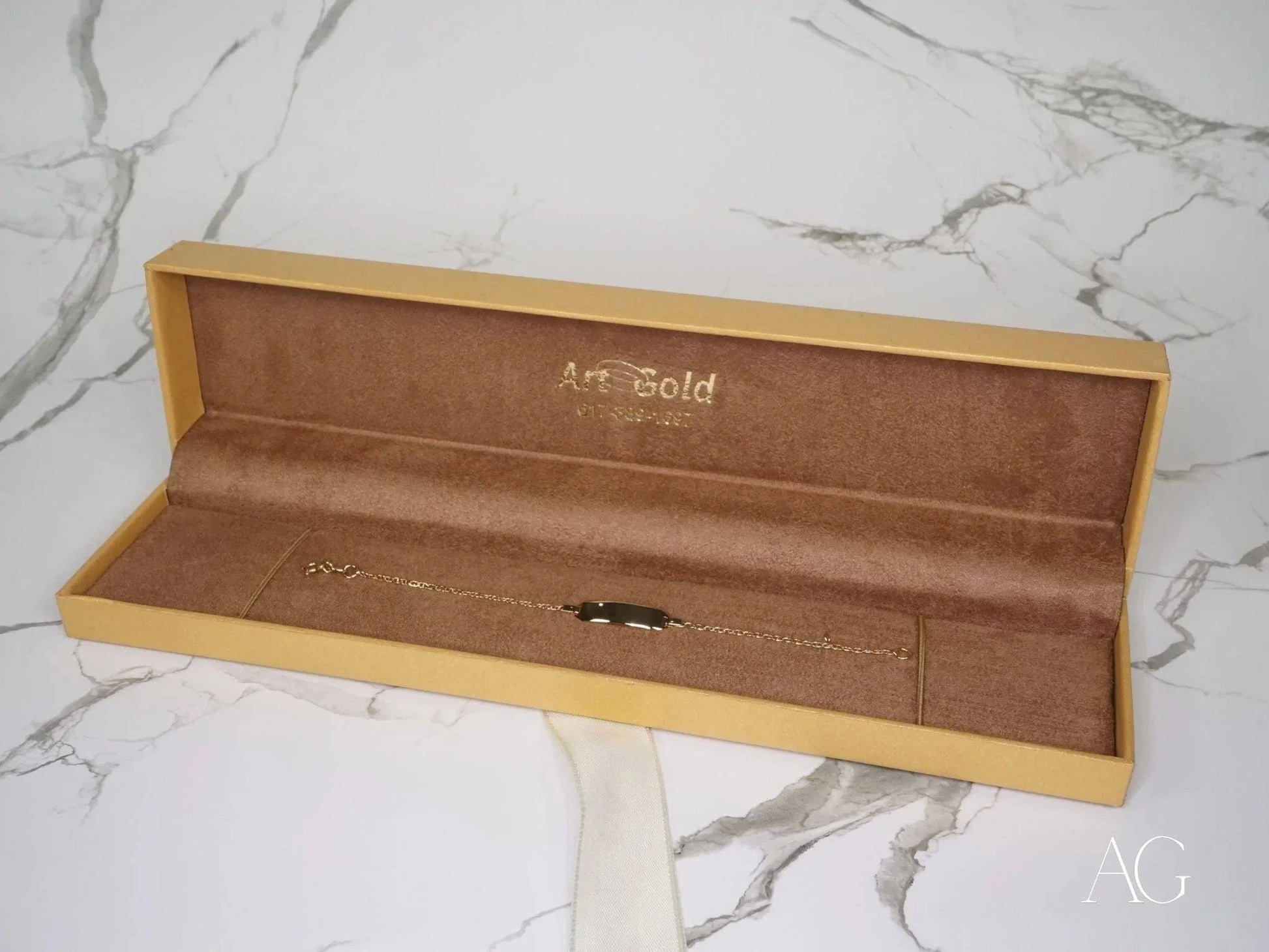 Yellow jewelry box with brown velvet showcasing a Personalized 18k gold kid’s bracelet