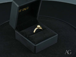 Gold Radiant Vow Engagement Ring with center diamond in a black jewelry box