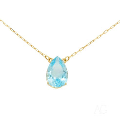 Teardrop light blue gemstone pendant on 18 carat gold necklace showcasing Blue Topaz