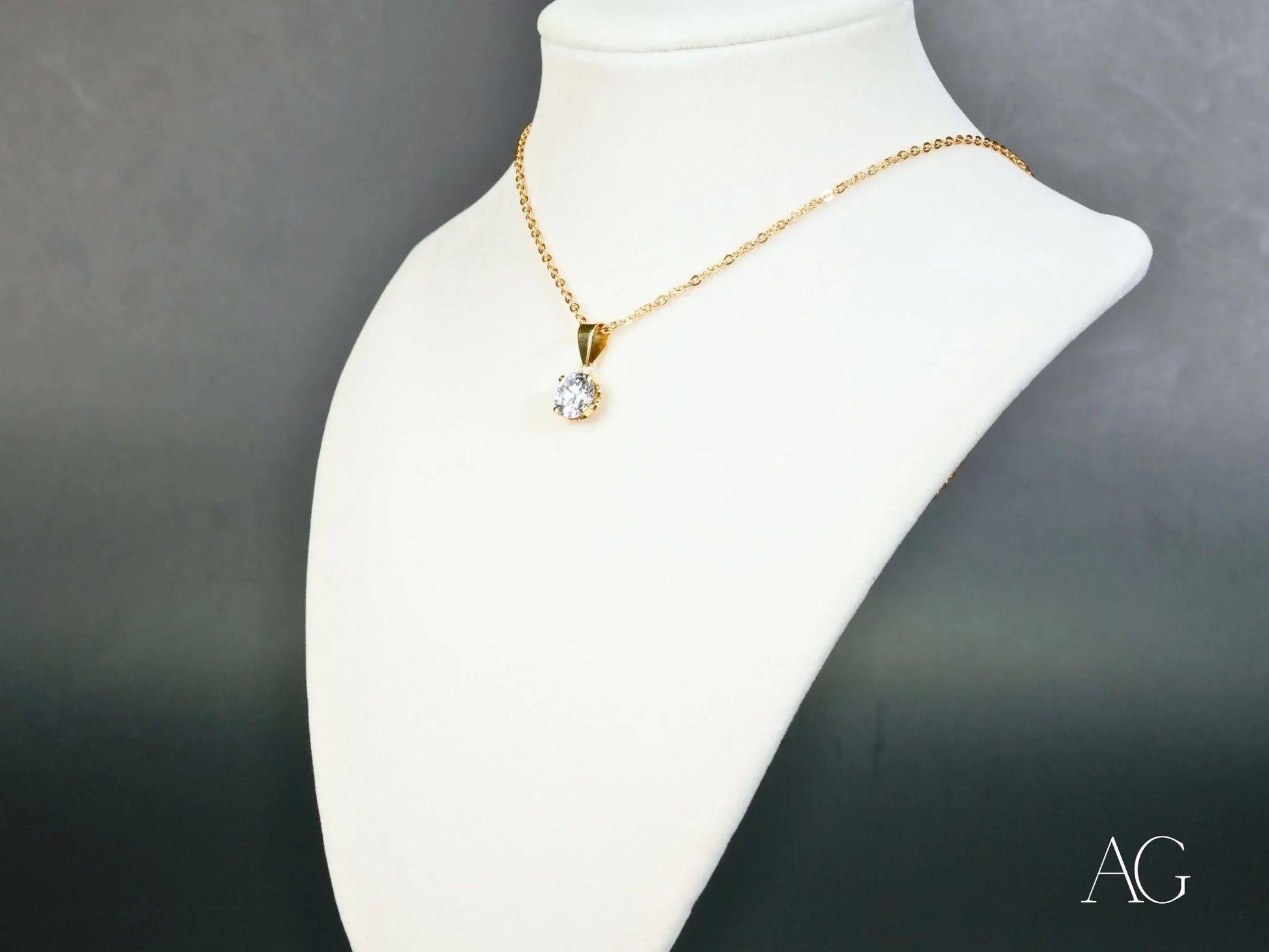 Gold chain necklace with a Radiant Solitaire cubic zirconia pendant on a white bust