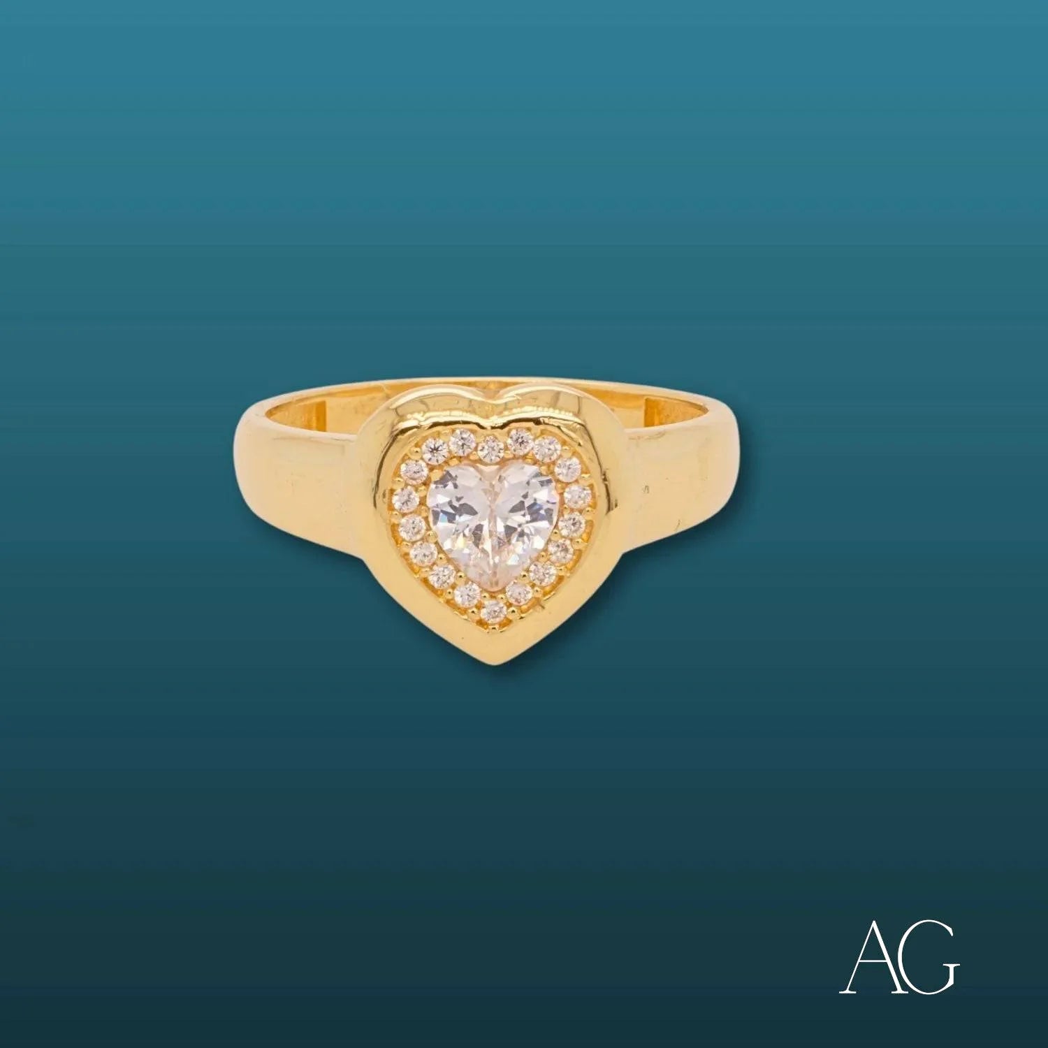 Gold heart-shaped ring featuring a diamond and white CZs in 18k gold design