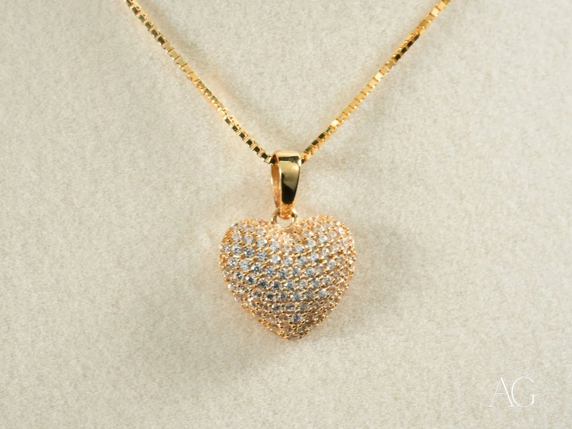 Radiant Heart Pendant featuring an 18k gold heart pendant with sparkling crystals