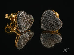 Heart-shaped stud earrings with pave diamonds and luminous 18k gold posts from Radiant Love