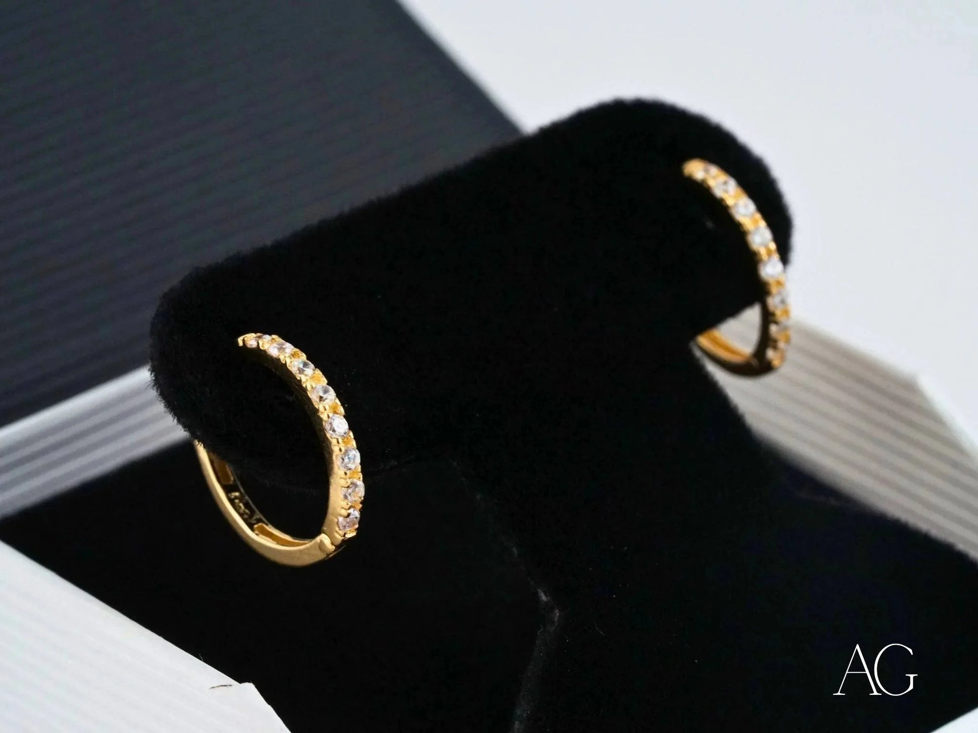 Gold hoop earrings with inset diamonds set in 18k yellow gold for elegant style