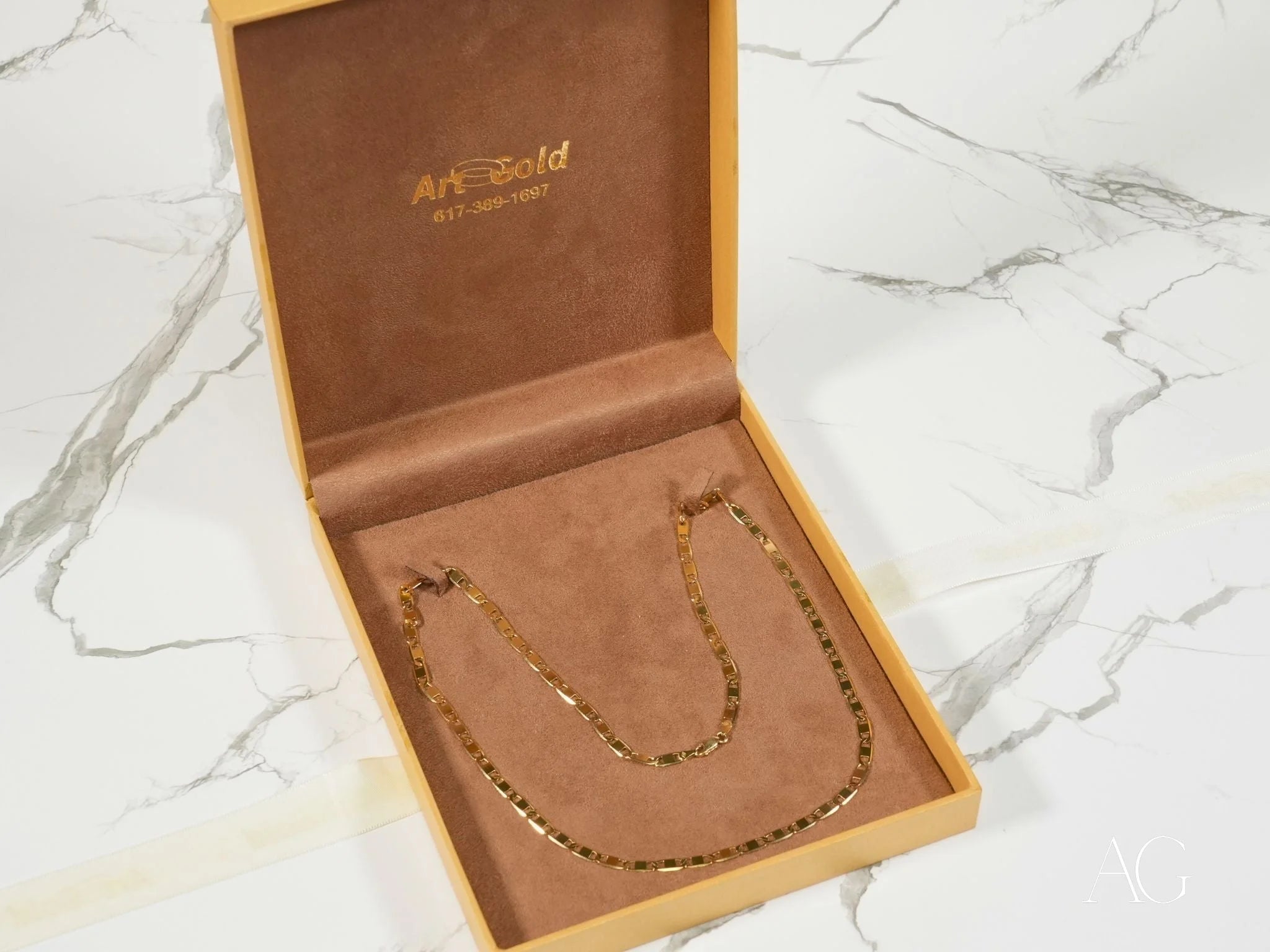 Gold necklace in presentation box, showcasing Regal Brilliance 18K Piastrine Flat Necklace