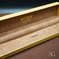 Gold jewelry box with velvet lining and Art Gold branding for 18k solid gold crown motif bracelet