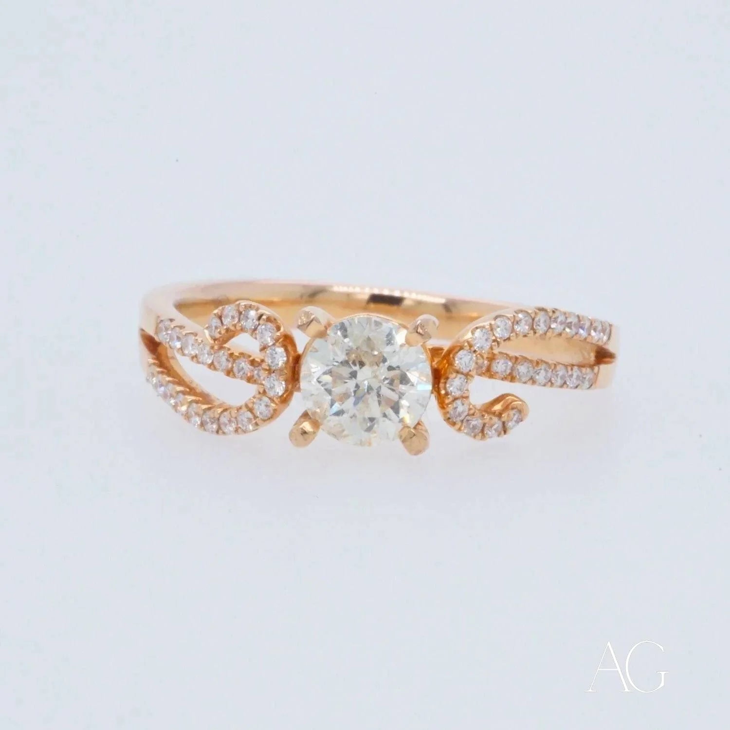 Delicate 18k rose gold diamond ring with pavé-set bands and central diamond