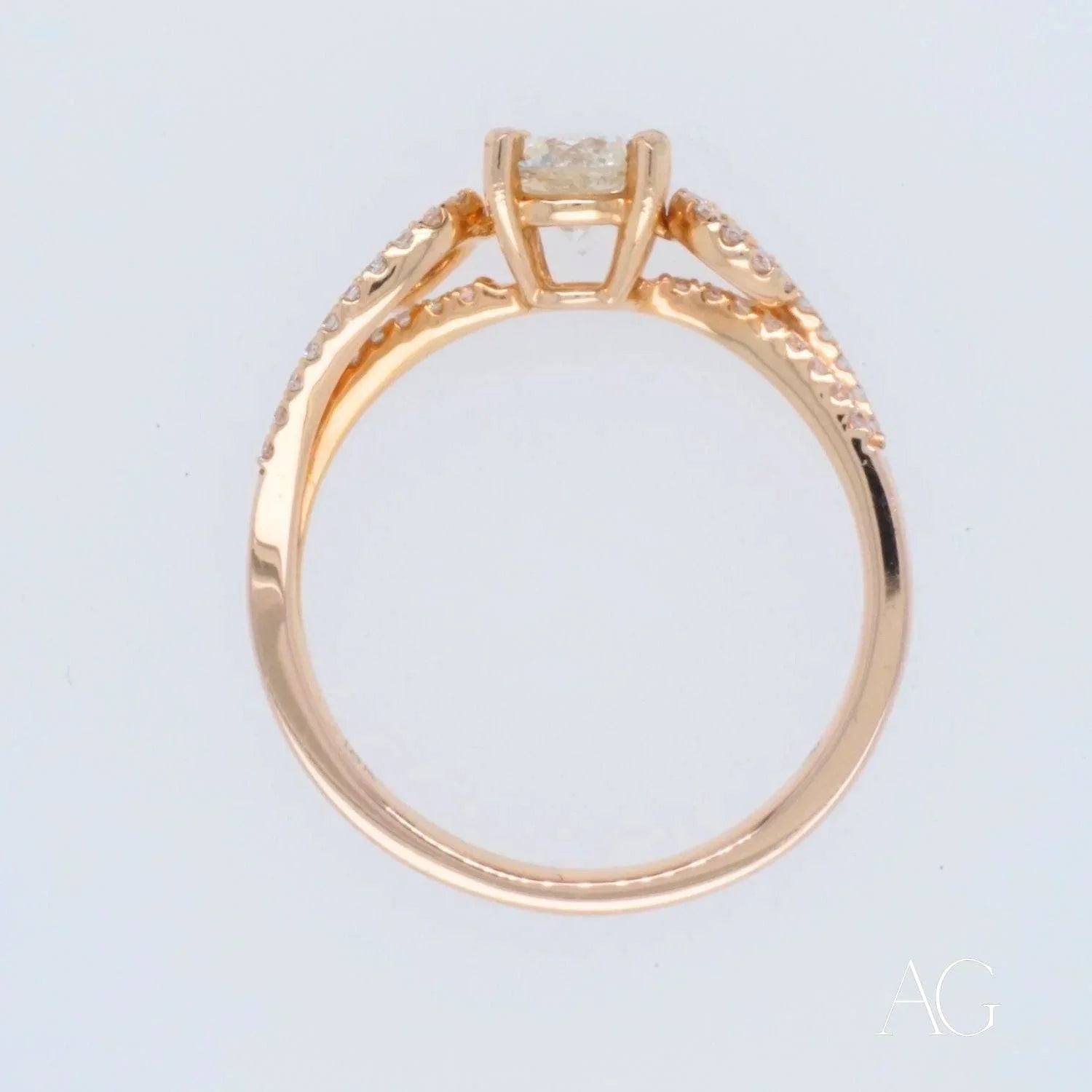 Gold engagement ring in 18k rose gold featuring a central diamond and intricate details