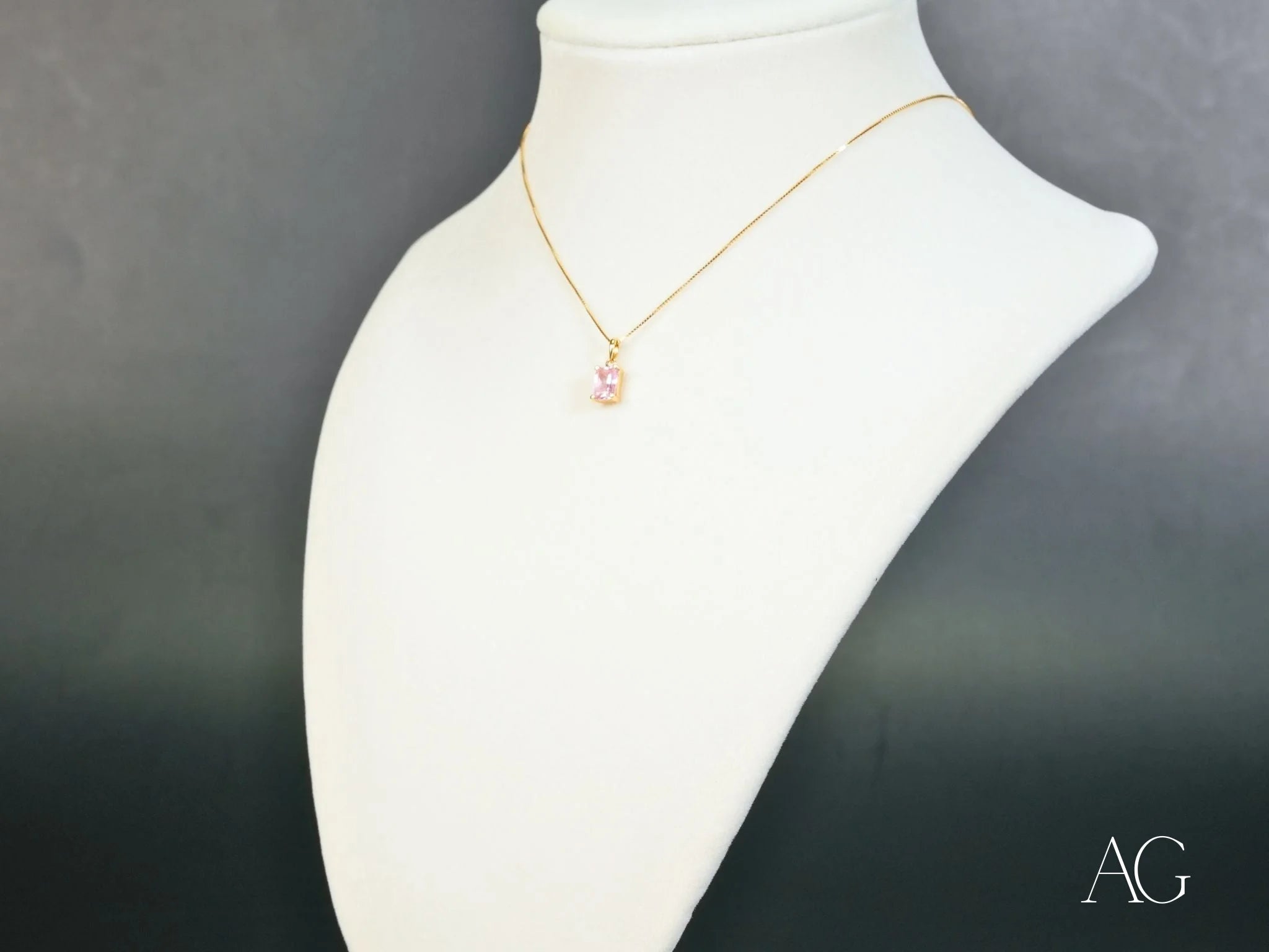 Delicate 18k gold chain necklace with pink cubic zirconia pendant on white bust