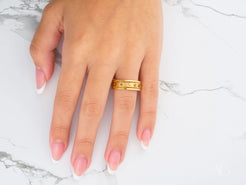 Gold ring with textured accents on pink-tipped nails, Royal Crest 14k Gold Wedding Band