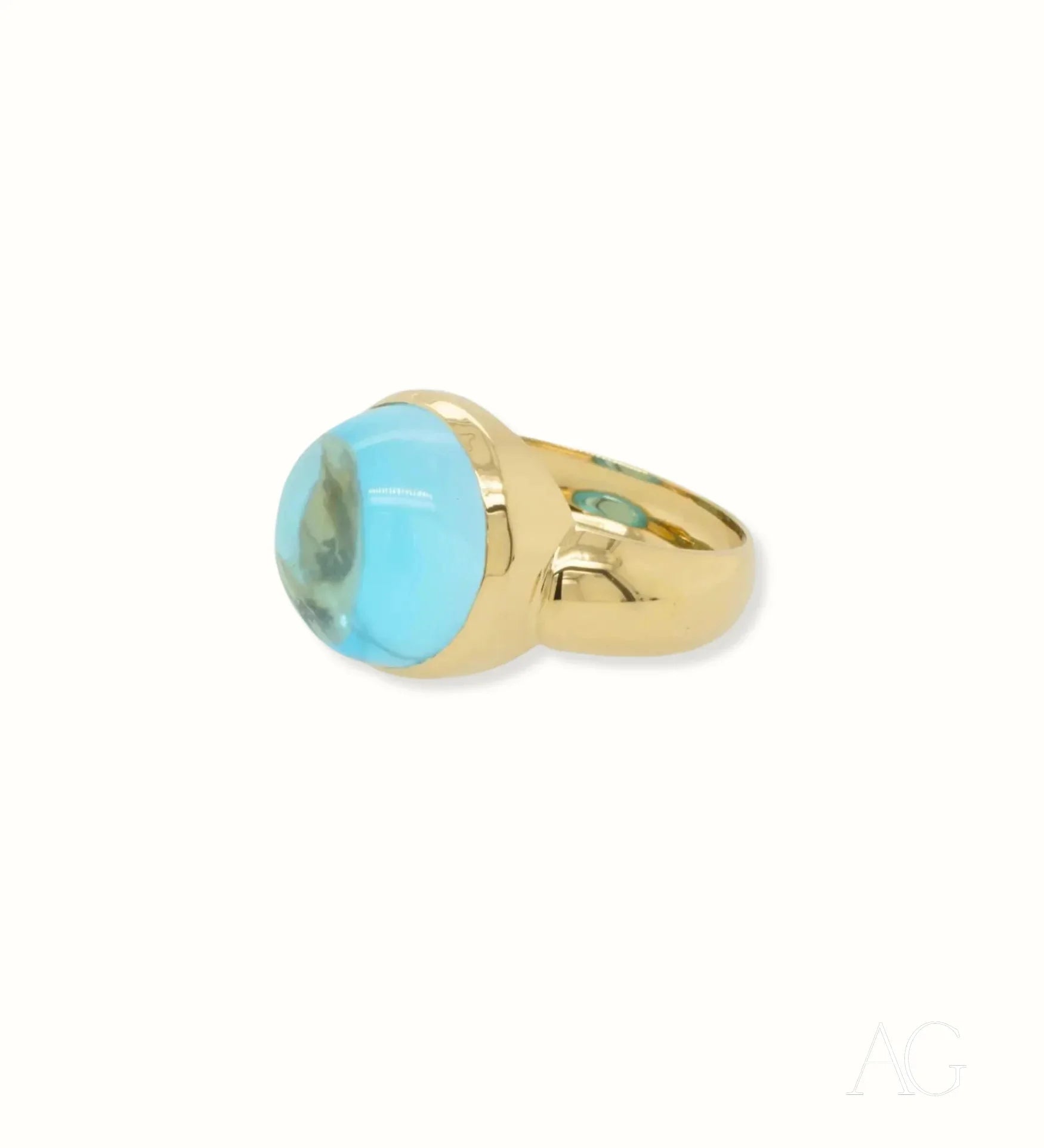 Gold ring featuring a stunning cabochon blue topaz gemstone in Serenity in Blue design