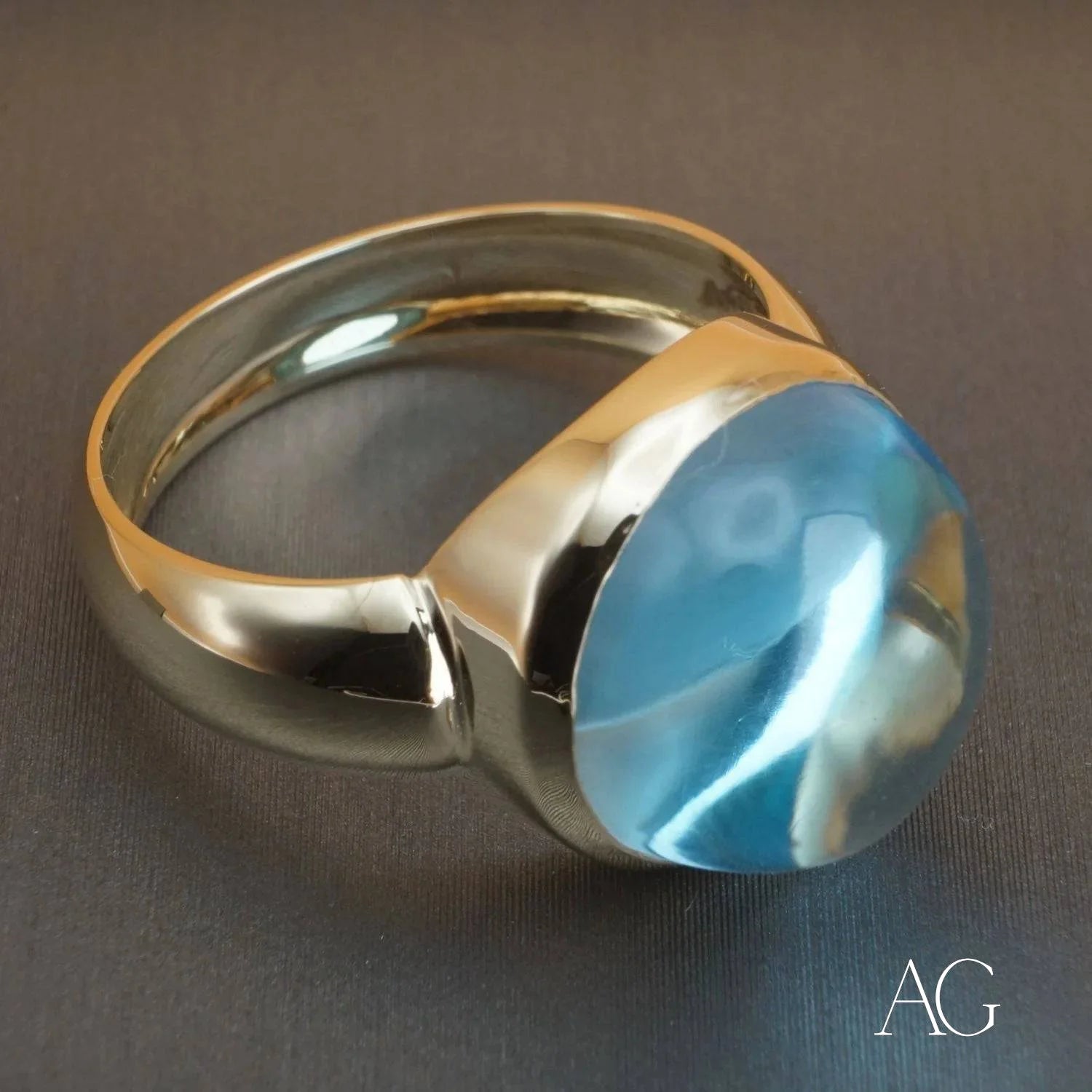 Gold ring with cabochon blue topaz gemstone in Serenity in Blue design