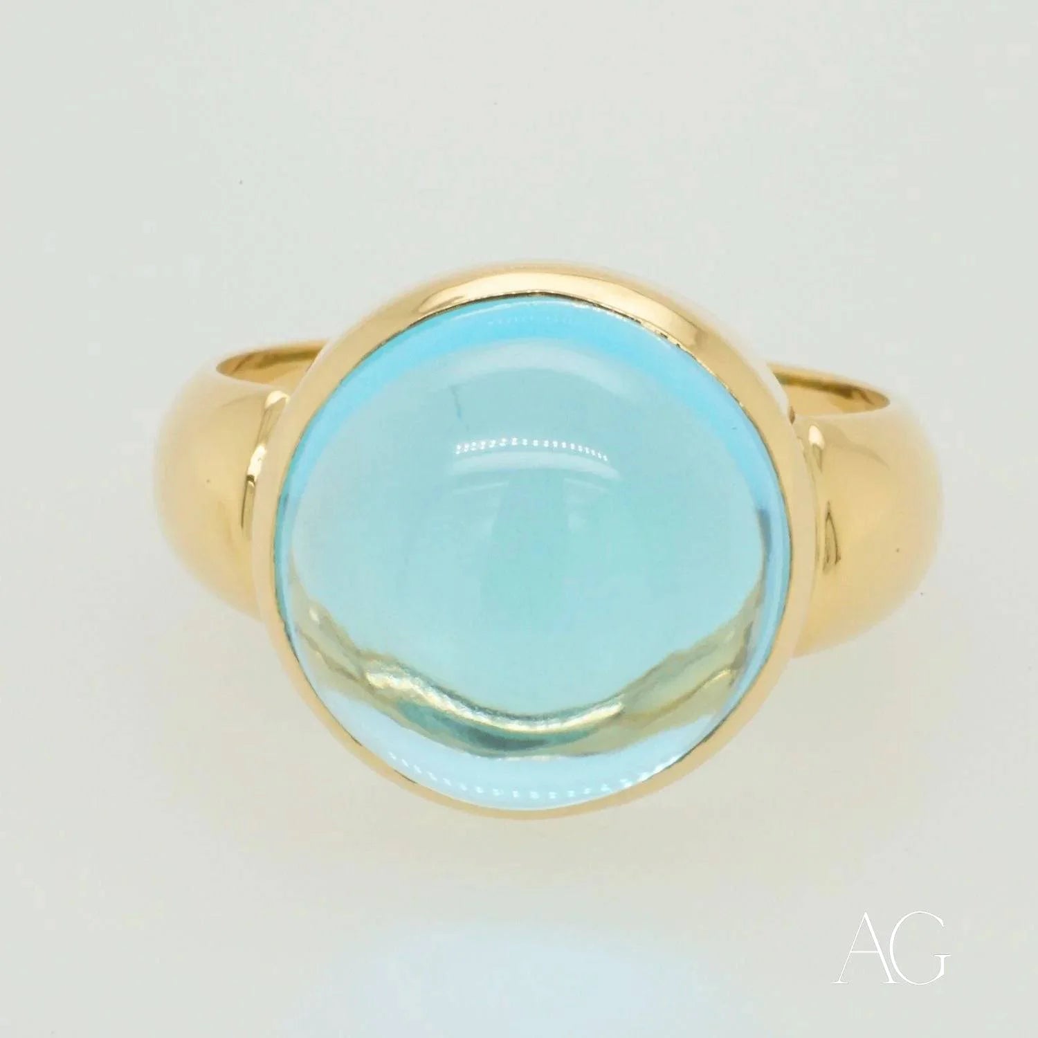 Gold ring with cabochon blue topaz gemstone in Serenity in Blue collection