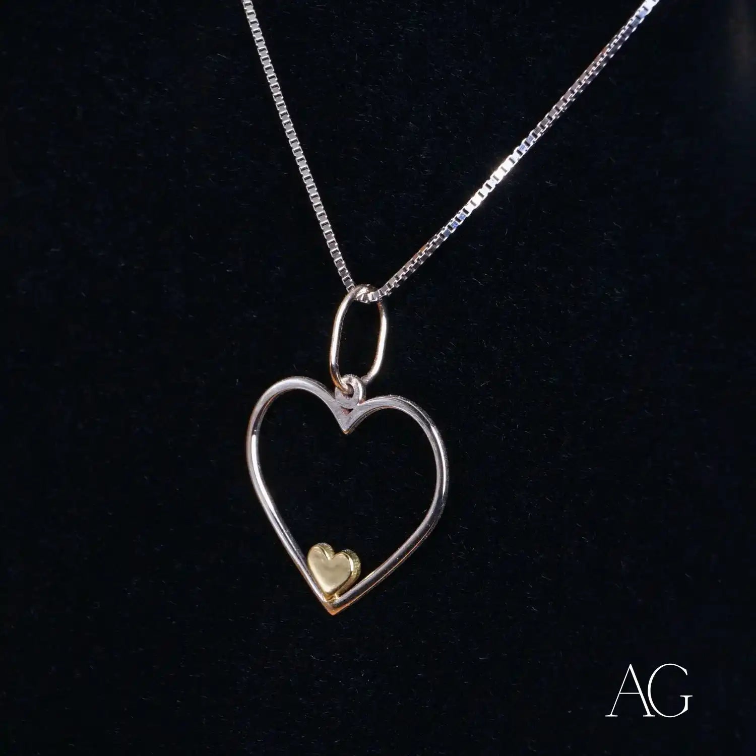 Heartfelt glint pendant featuring a heart-shaped sterling silver design with gold accent