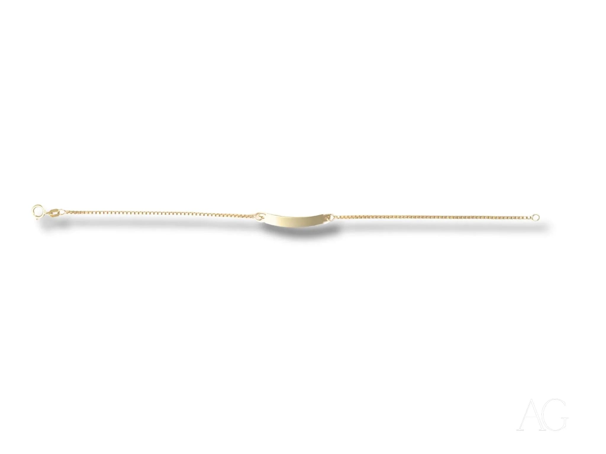 Long, thin medical catheter with a curved tip next to Solid 18k Gold kids bracelet