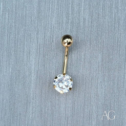 Gold belly button ring featuring a clear cubic zirconia in 18k gold design