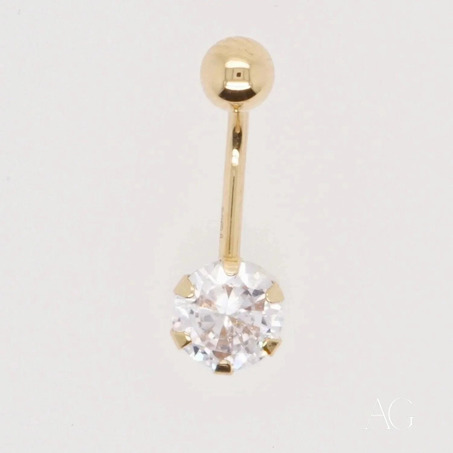 Gold belly button ring featuring a clear round cubic zirconia in 18k gold design