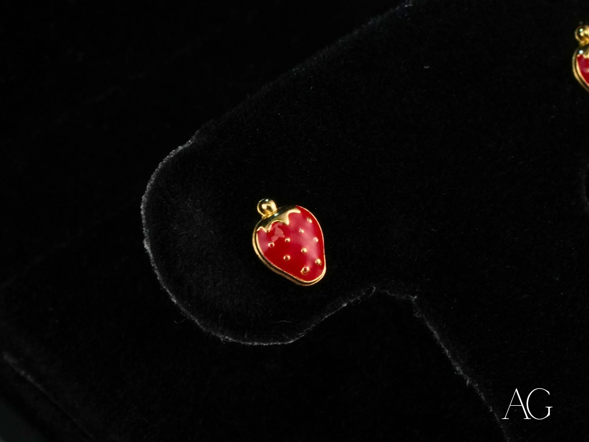 Sweet Strawberry earrings featuring strawberry-shaped gold and red enamel stud design