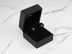Sweet Strawberry Earrings in a black jewelry box, featuring 18k Gold Kids Enamel Stud Earrings