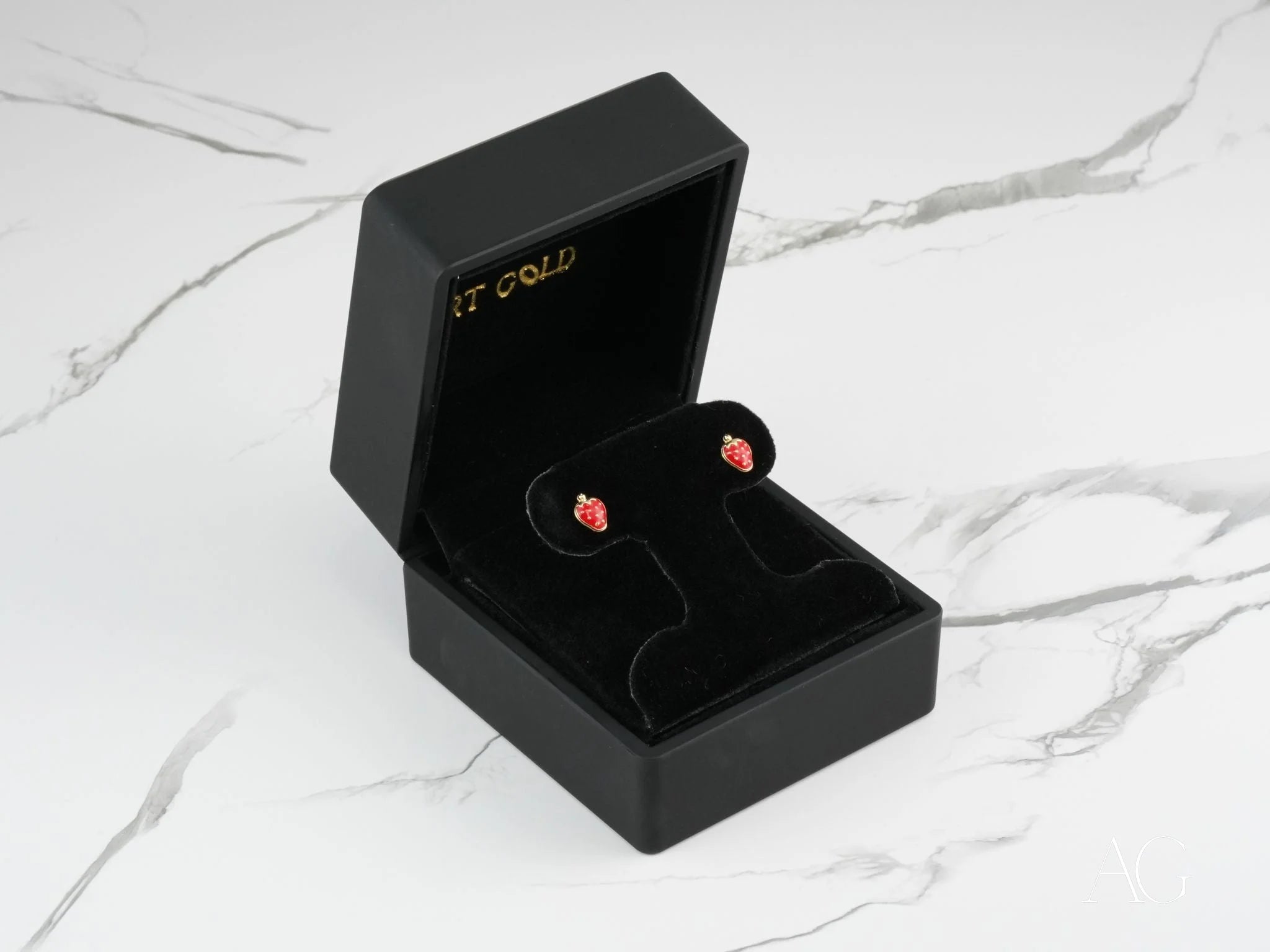 Sweet Strawberry Earrings in a black jewelry box, featuring 18k Gold Kids Enamel Stud Earrings