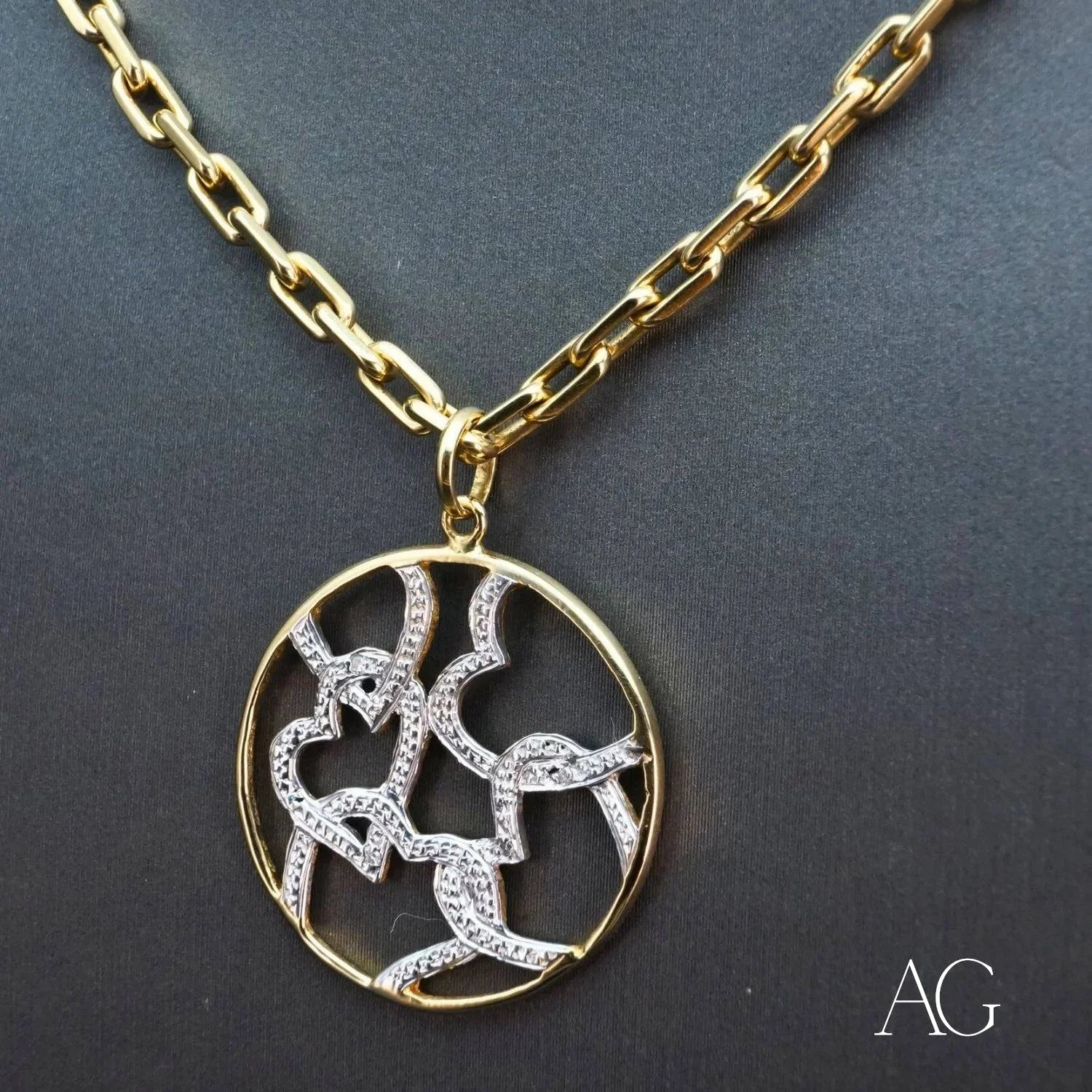 Gold chain necklace with a white gold hearts pendant featuring diamond-adorned hearts