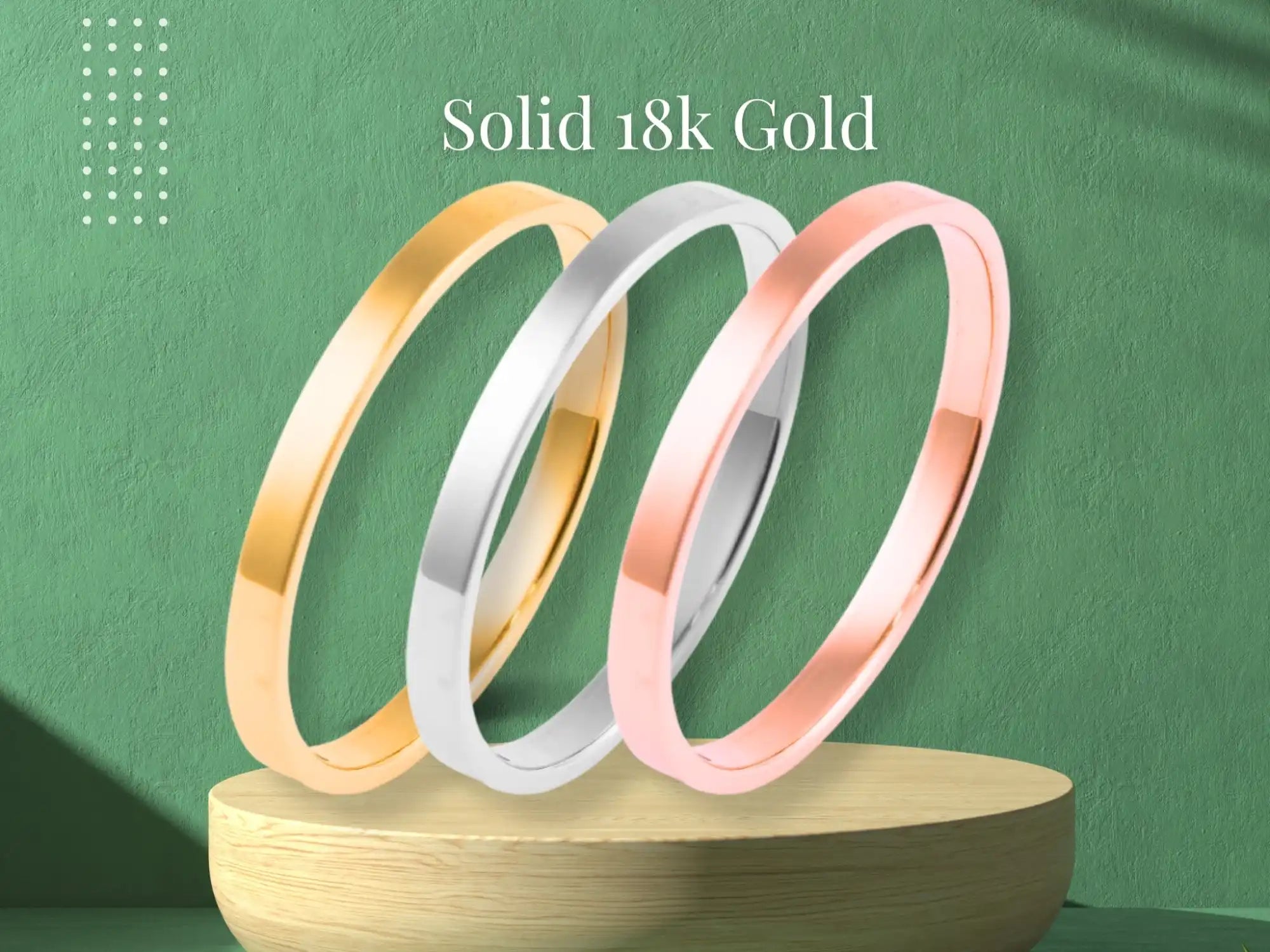 Three solid 18k gold rings in yellow, white, and rose gold colors.