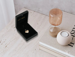 Heart-shaped ring in a black box for 18k gold Trinity Heart Pendant