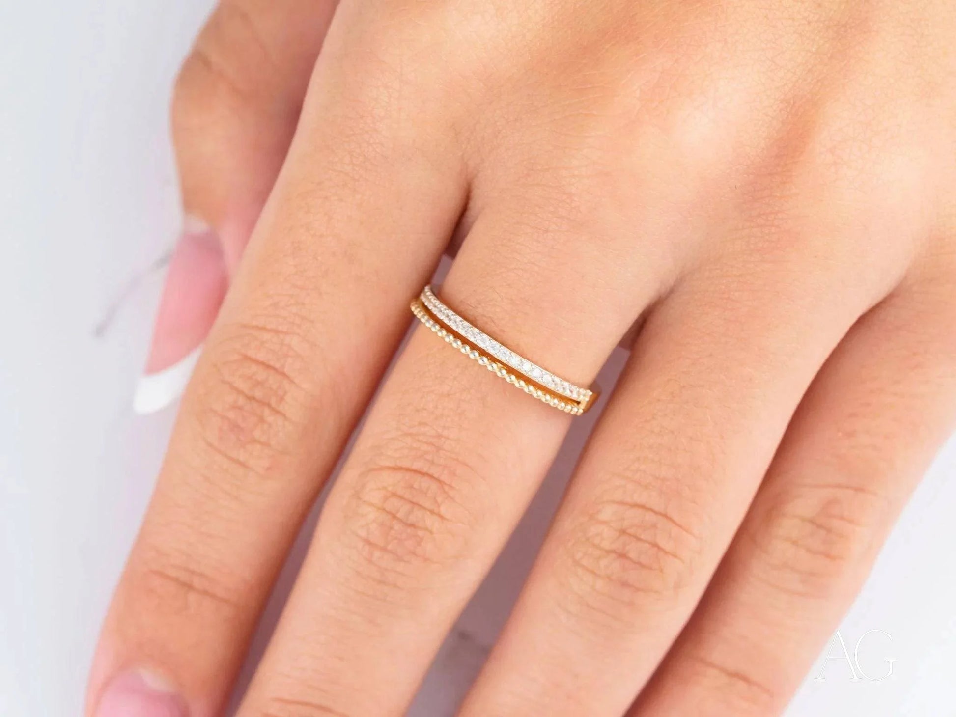 Delicate 18k yellow gold ring with two bands, showcasing timeless elegance and beauty